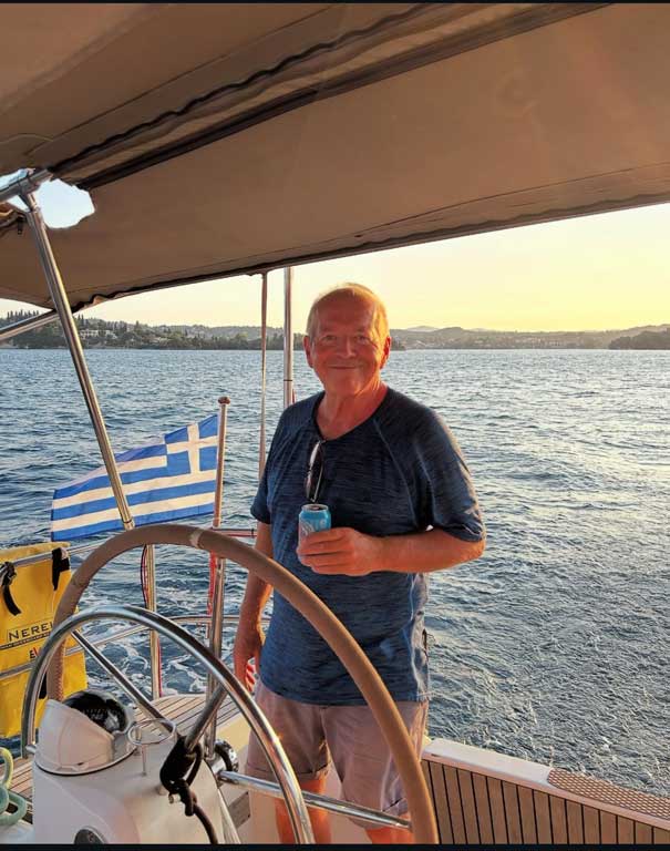 David McRae, co-founder of Sailorsbreeze, aboard at sunset